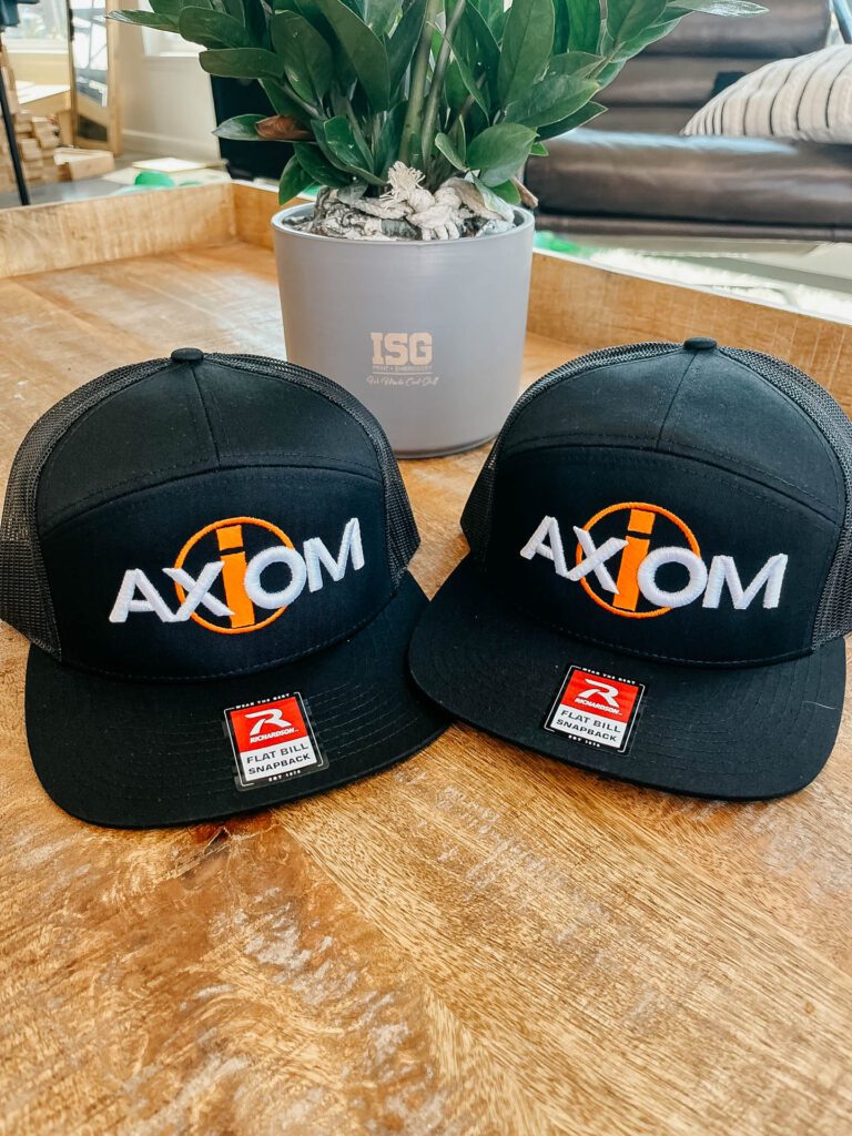 Axiom hats on wood table