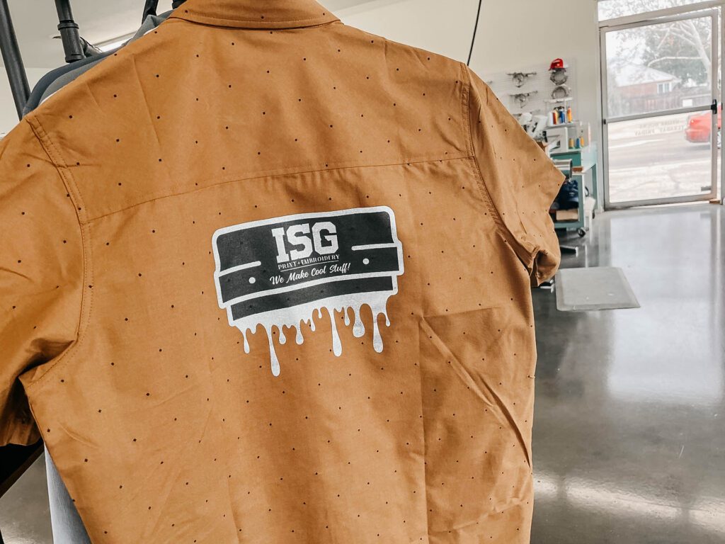 ISG Print logo on back of orange shirt